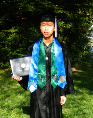 Johnny Moua holding his diploma